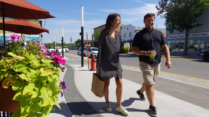 two people walking along Manitoba Ave