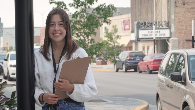 Ellie Longbottom, Culture Coordinator standing outside with a clipboard