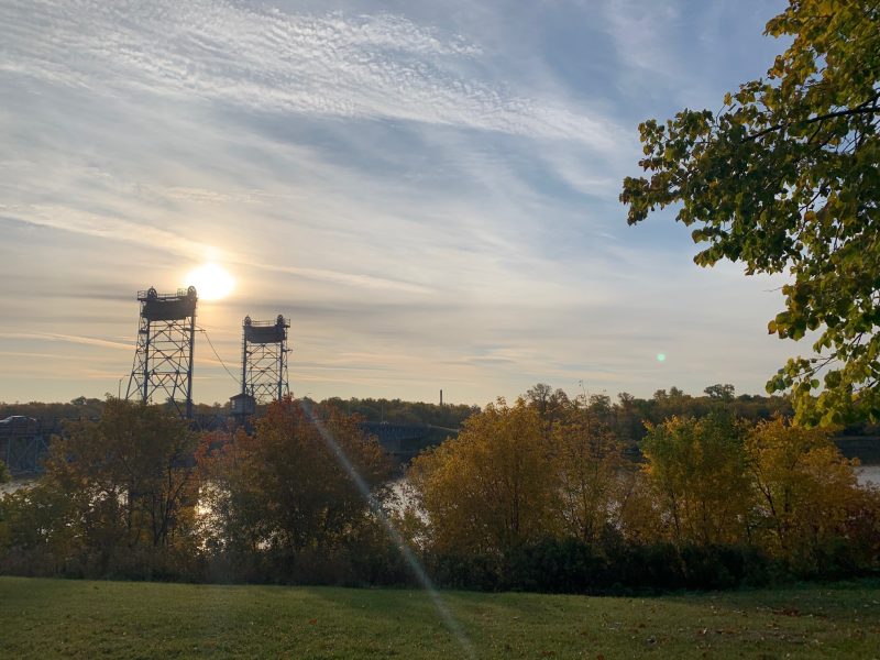 outside view of the Selkirk bridge showing trees, grass and water in the fall