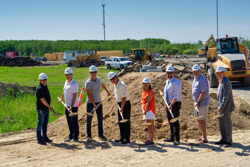 part of Council, City staff and contractors with shovels in hand ready to start construction