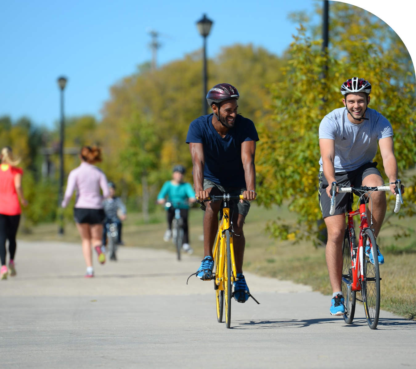 Photo showing people walking and cycling along an active transportation pathway, representing Selkirk’s lifestyle and livability as a competitive advantage.